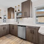 Kitchen with wood cabinetry and natural light in an Affordable Living Company home