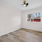 Empty furnished-ready bedroom with hardwood floors in an Affordable Living Company home