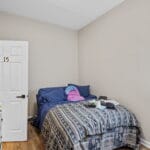 Furnished bedroom with natural light in an Affordable Living Company home