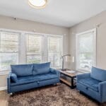 Shared living room with sofas in an Affordable Living Company home