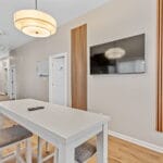 Common area with wall-mounted TV in an Affordable Living Company shared housing home