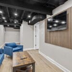 Common living area with sofa and accent wall in an Affordable Living Company home