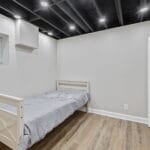 Furnished bedroom with a single bed in an Affordable Living Company shared housing home