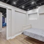 Furnished bedroom with a single bed in an Affordable Living Company home