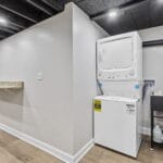 Laundry area with stacked washer and dryer in an Affordable Living Company home