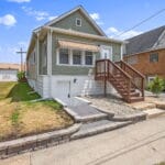Front exterior view of an Affordable Living Company home with landscaped yard
