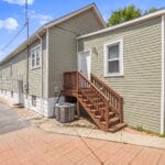Side exterior view of an Affordable Living Company home with stairway entrance