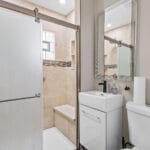 Bathroom with shower and vanity in an Affordable Living Company home