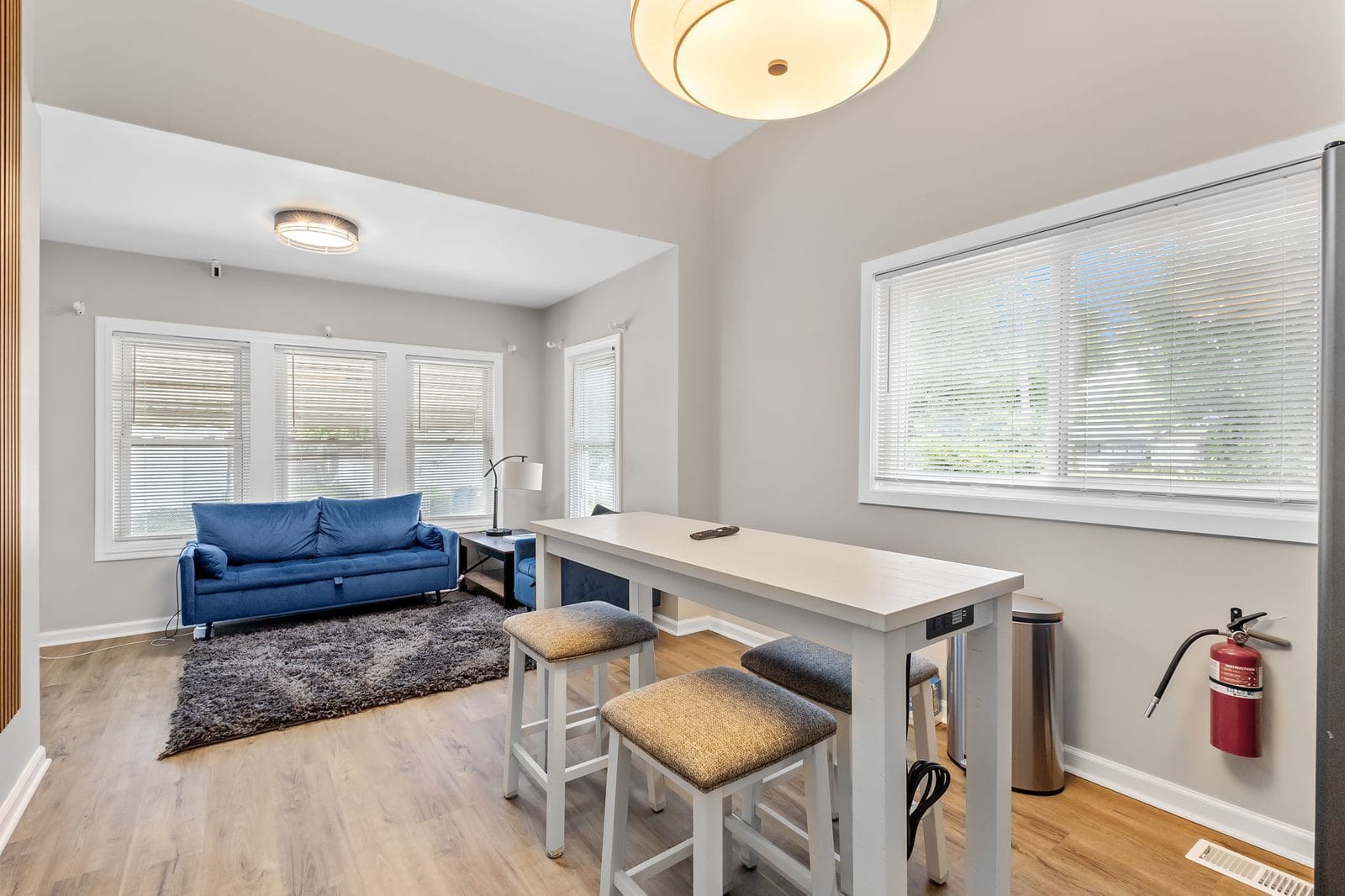 Common area with dining table, stools and seating in shared housing in Hammond, Indiana