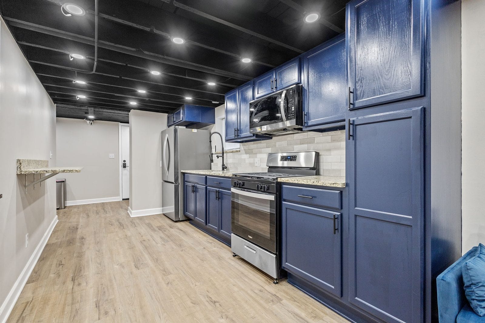 Lower level kitchen with blue cabinets and stainless steel appliances in Hammond, Indiana