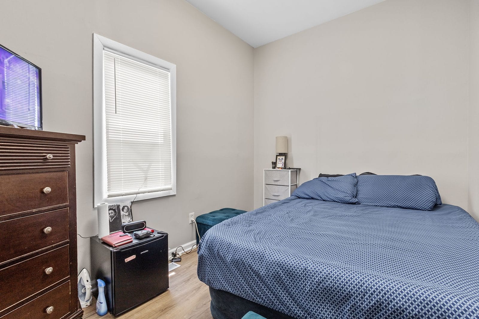 Private furnished bedroom with bed, dresser and window in Hammond, Indiana